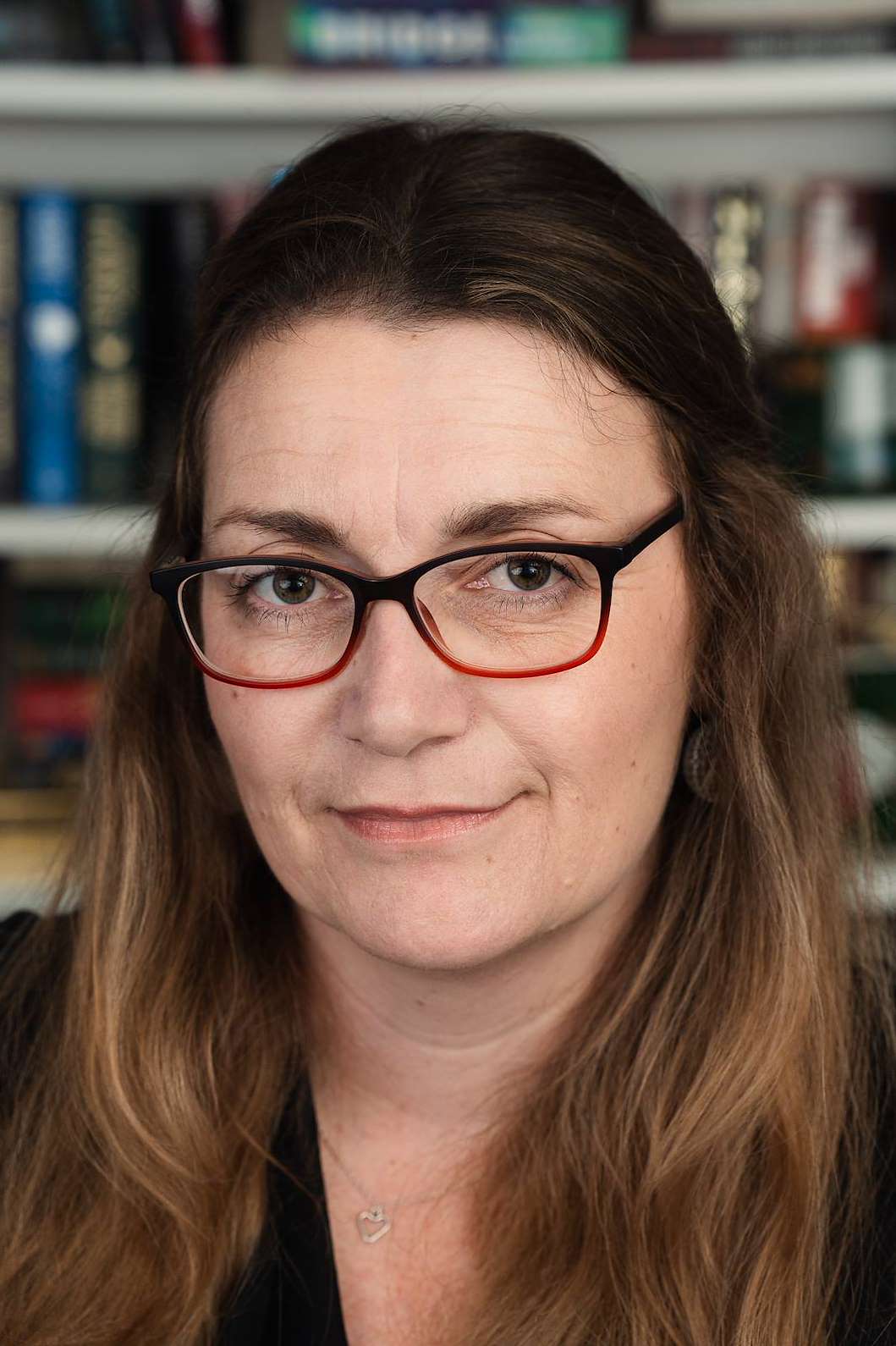 Headshot of Sarah looking directly at the camera and smiling slightly